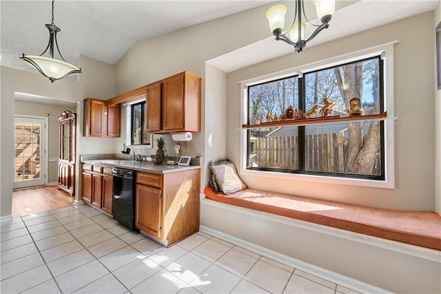 kitchen with brown cabinetry, a healthy amount of sunlight, dishwasher, and light tile patterned floors