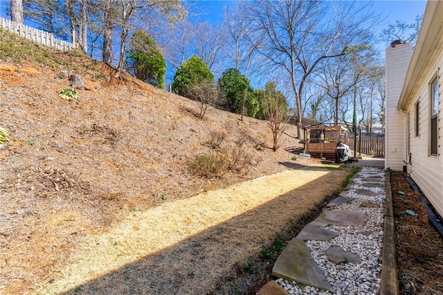 view of yard with fence and a wooden deck