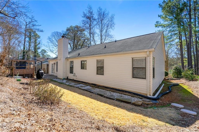 back of property with a chimney