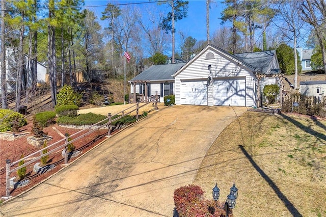 ranch-style home with a garage, concrete driveway, and a front yard