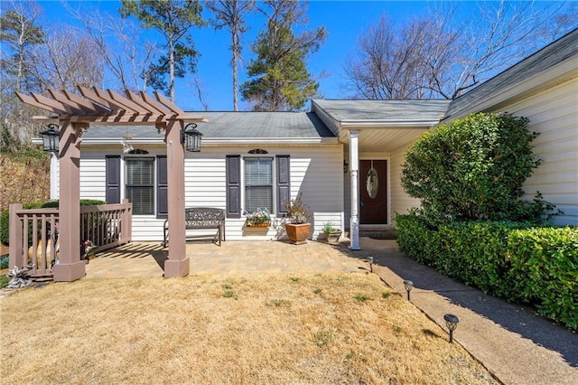 exterior space featuring a patio area, a pergola, and a yard