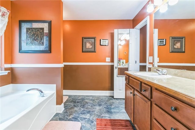 bathroom with a tub to relax in and vanity