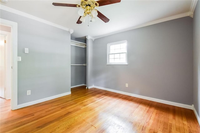 unfurnished bedroom featuring crown molding, light wood-style flooring, a closet, and baseboards
