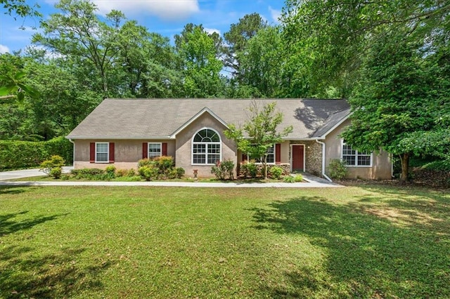 single story home featuring a front yard and stucco siding