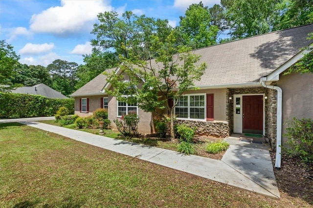 view of front of property featuring stucco siding, stone siding, a front lawn, and a shingled roof