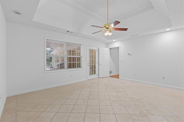 empty room with a raised ceiling, a ceiling fan, baseboards, and recessed lighting