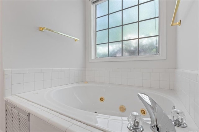 bathroom with healthy amount of natural light and a whirlpool tub