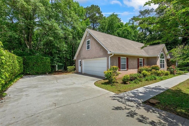 view of home's exterior featuring stucco siding and driveway