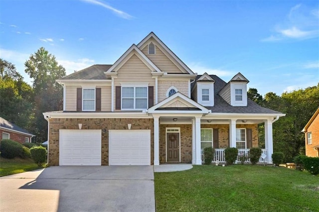 craftsman-style house with a porch, a garage, and a front yard