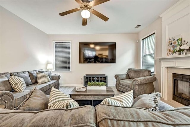 living room with ceiling fan and wood-type flooring