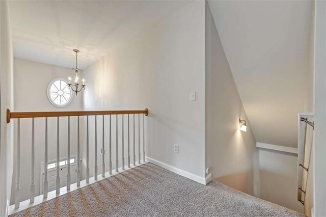 staircase featuring carpet and a chandelier