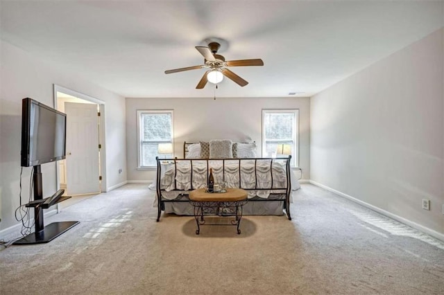 bedroom with ceiling fan and light carpet