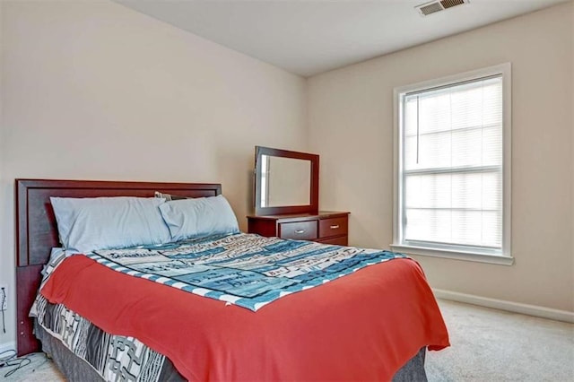 carpeted bedroom with multiple windows