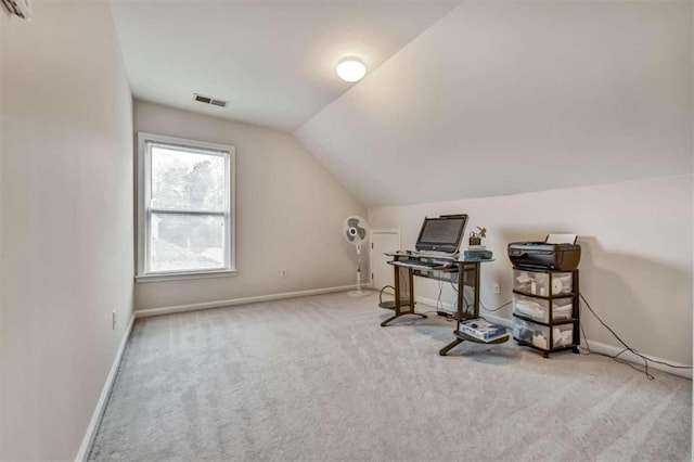 home office with light carpet and vaulted ceiling