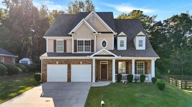 view of front of house with a porch, a garage, and a front yard