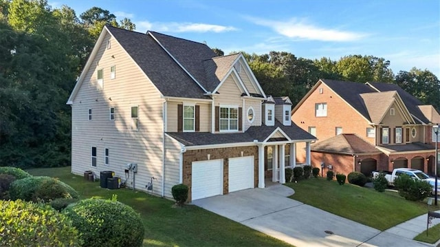 view of front facade with central AC unit, a front yard, and a garage