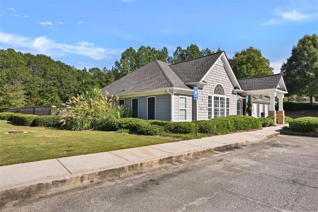 view of side of home with a yard