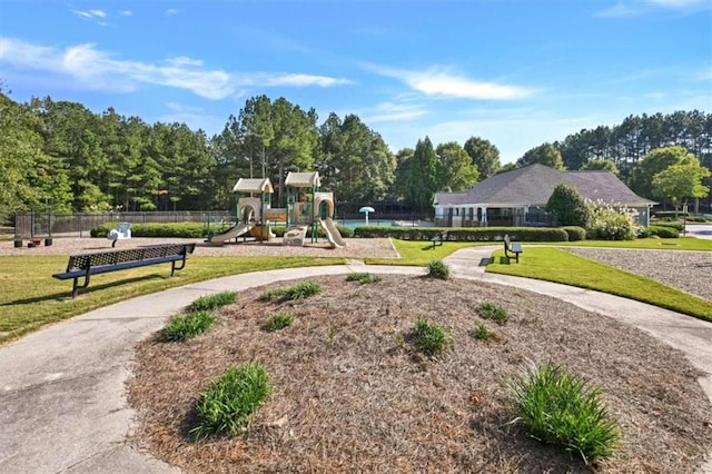 surrounding community with a yard and a playground