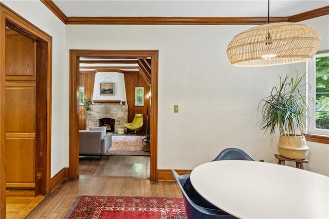 hallway featuring ornamental molding and hardwood / wood-style floors