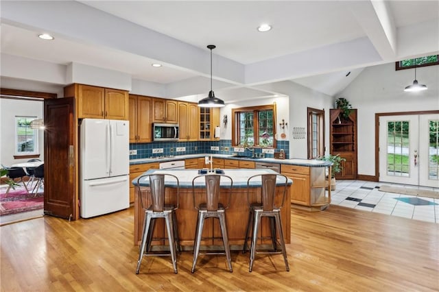 kitchen featuring light hardwood / wood-style floors, a wealth of natural light, and white fridge