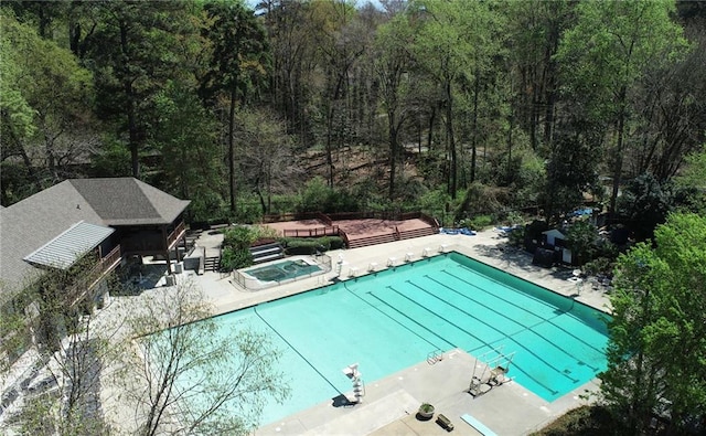 view of pool with a patio and a hot tub