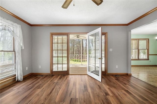 doorway to outside featuring ornamental molding, wood finished floors, baseboards, a textured ceiling, and a ceiling fan