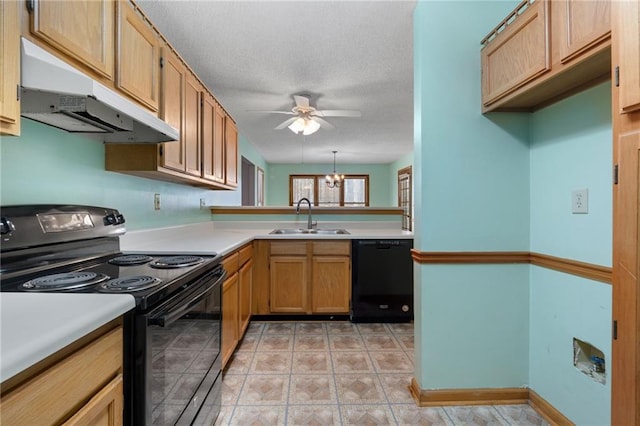 kitchen featuring a sink, light countertops, a ceiling fan, under cabinet range hood, and black appliances