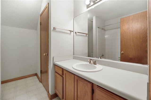 full bath with vanity, baseboards, tile patterned floors, and a shower