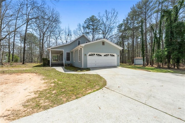 view of front of house featuring covered porch, an attached garage, concrete driveway, and a front yard