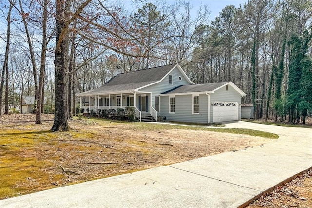 view of front of home featuring a porch, a garage, and concrete driveway