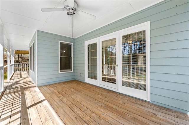wooden deck with a ceiling fan