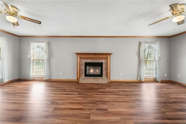 unfurnished living room featuring ceiling fan, a healthy amount of sunlight, and wood finished floors