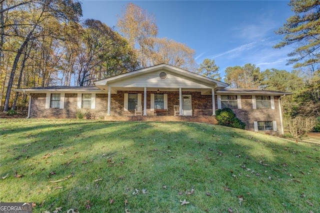 single story home with a front yard and covered porch