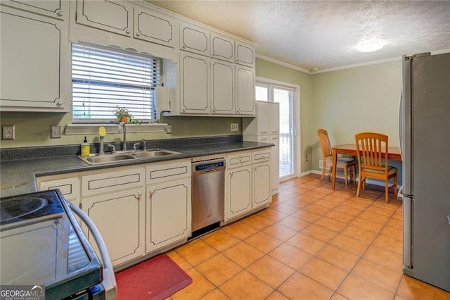 kitchen with light tile patterned flooring, sink, ornamental molding, stainless steel appliances, and a healthy amount of sunlight