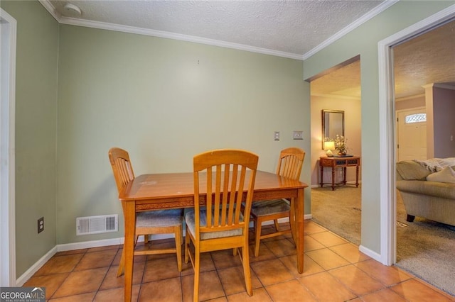 dining area with light carpet, crown molding, and a textured ceiling