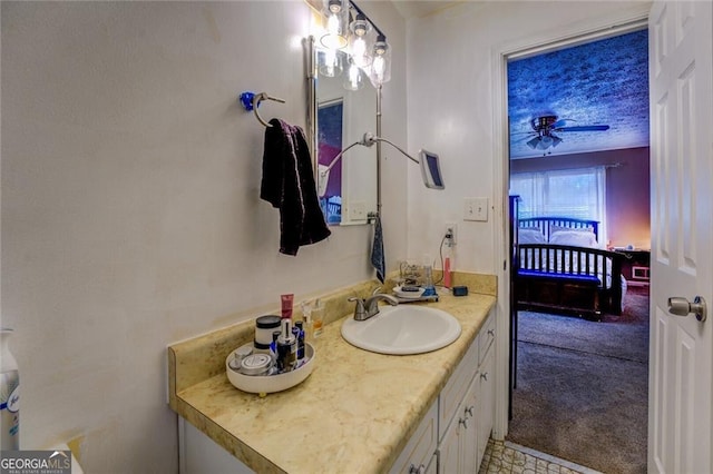 bathroom featuring ceiling fan, vanity, and a textured ceiling