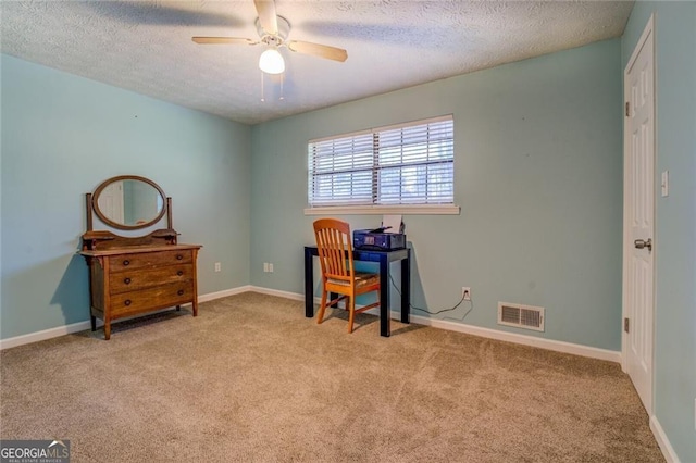 home office with ceiling fan, light carpet, and a textured ceiling