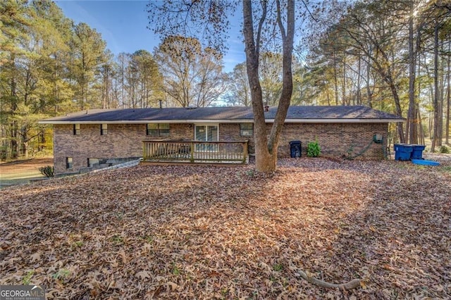 back of house with a wooden deck