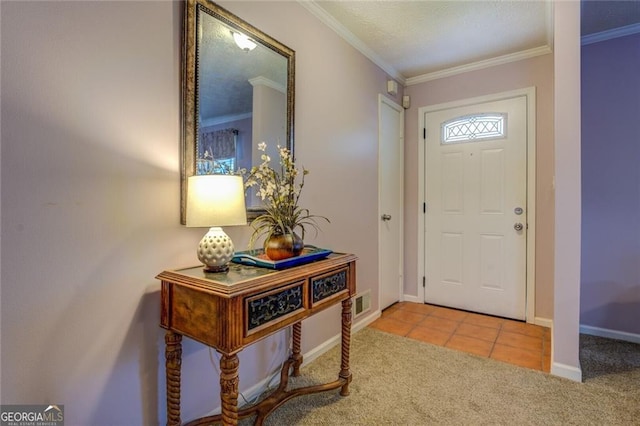 foyer entrance with ornamental molding and carpet floors