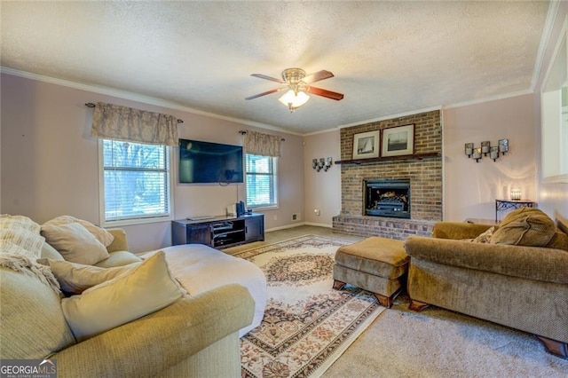 living room featuring crown molding, ceiling fan, carpet flooring, a fireplace, and a textured ceiling