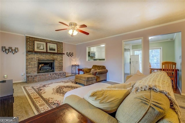 carpeted living room featuring ceiling fan, ornamental molding, and a fireplace