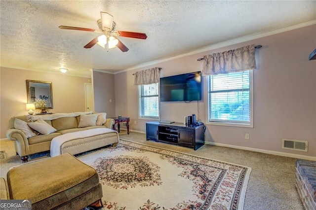 carpeted living room featuring ceiling fan, crown molding, and a textured ceiling