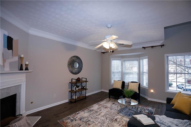 living room with dark hardwood / wood-style flooring, ornamental molding, and ceiling fan