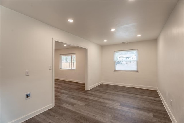 unfurnished room featuring dark wood-type flooring