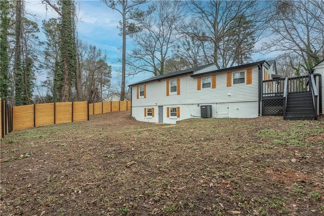 back of house with central AC and a deck