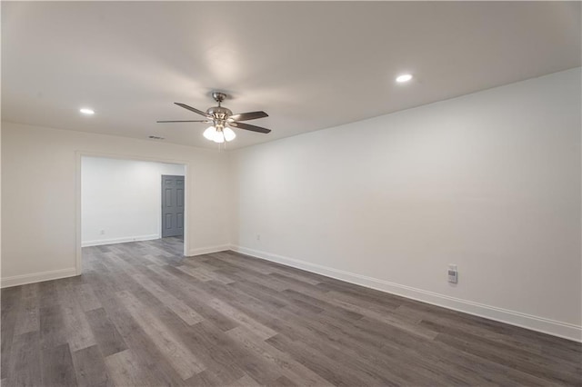 empty room with dark wood-type flooring and ceiling fan