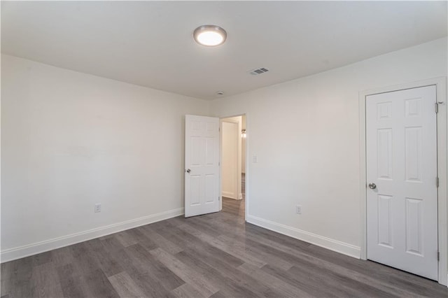 unfurnished room featuring dark hardwood / wood-style floors