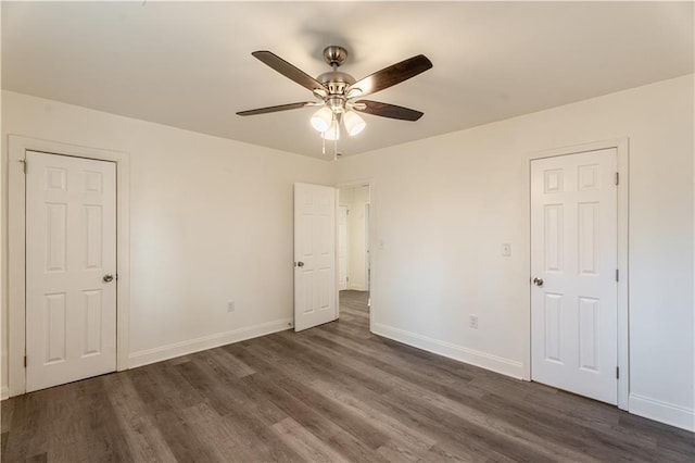 unfurnished bedroom featuring dark hardwood / wood-style flooring and ceiling fan