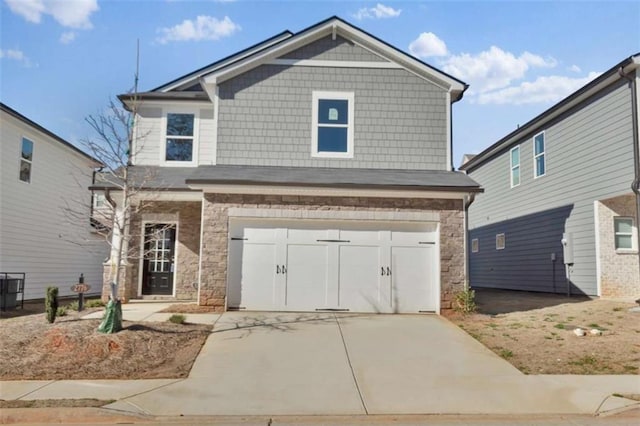 2766 Aralynn Way, College Park, GA 30337 - view of front of home with stone siding, an attached garage, and concrete driveway