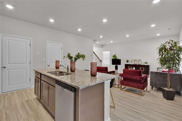 2766 Aralynn Way, College Park, GA 30337 - kitchen featuring dishwasher, a sink, light wood-type flooring, an island with sink, and light stone countertops